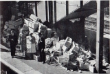 The stationmaster and his wife with broken packing cases on a platform at Reading station.