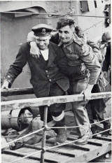 A member of the Auxiliary Military Pioneer Corps, a veteran of WW1, is helped ashore at Dover.